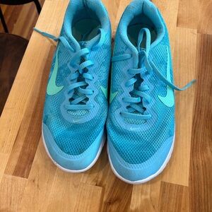 Cute blue running shoes with green Nike strips